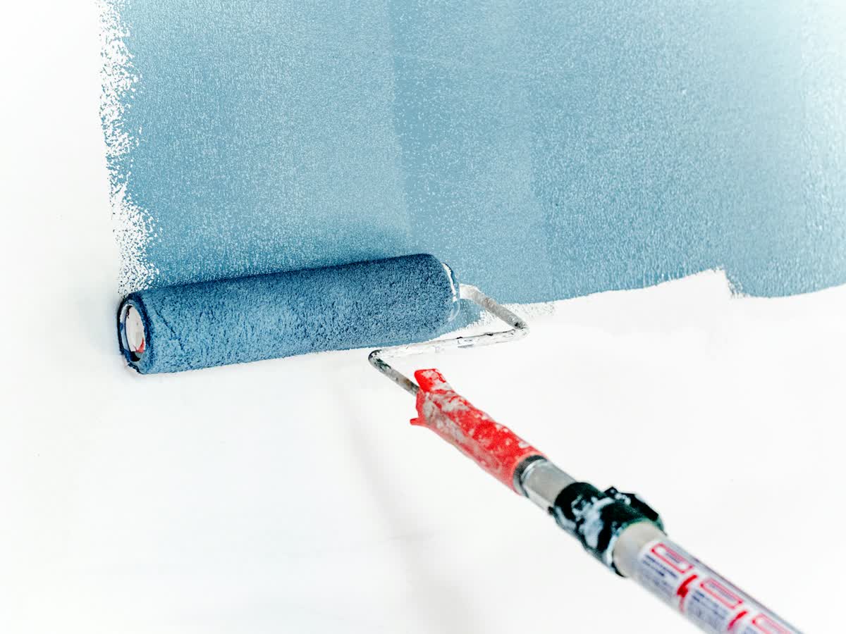 A roller applying interior paint for painting work in South Africa